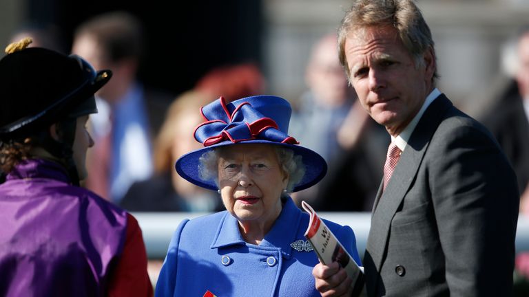 Queen Elizabeth II with jockey Tom Queally and trainer Michael Bell