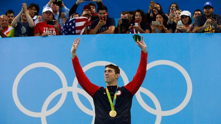 Gold medalist Michael Phelps of the United States poses on the podium in Rio