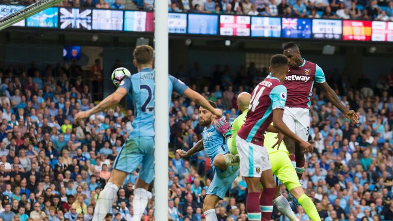 West Ham United's English midfielder Michail Antonio (R) heads West ham's first goal during the English Premier League football match between Manchester Ci