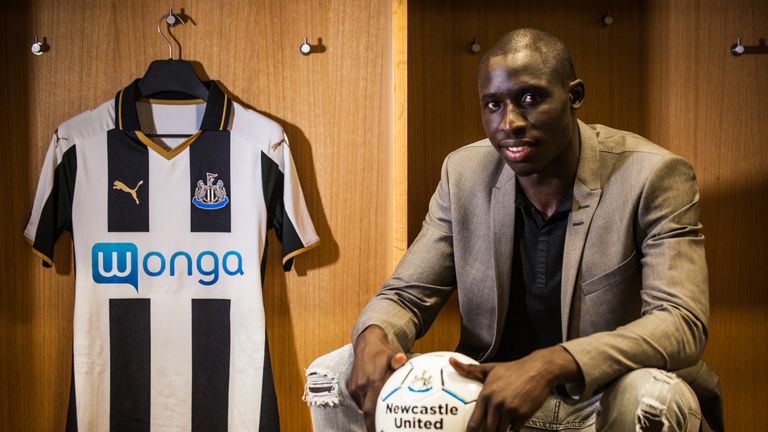 NEWCASTLE, ENGLAND -  AUGUST 2: Mohamed Diame poses for a photograph  in the home dressing room with a home shirt  whilst holding a football at St.James' P