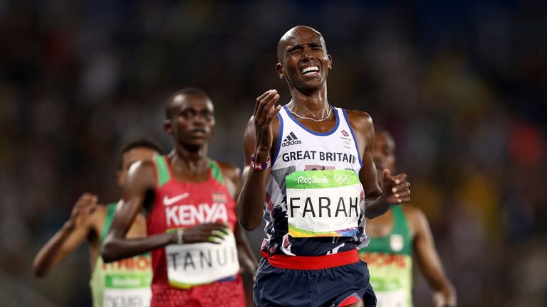 Farah grimaces as he crosses the line to win the 10,000m after a tough race