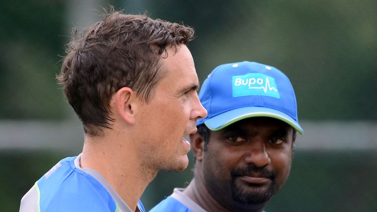 Australia's bowling consultant, Sri Lankan former cricketer Muttiah Muralitharan (R) speaks with Australian cricketer Stephen O'Keefe during a practice ses