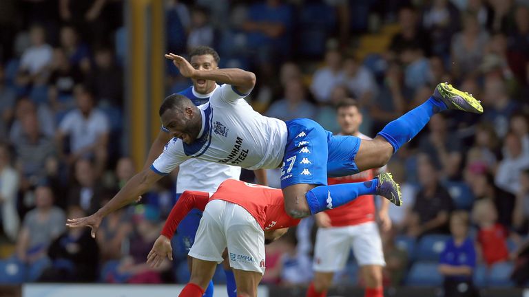 Bury's Nathan Cameron (top) and Charlton Athletic's Nicky Ajose collide on the pitch.