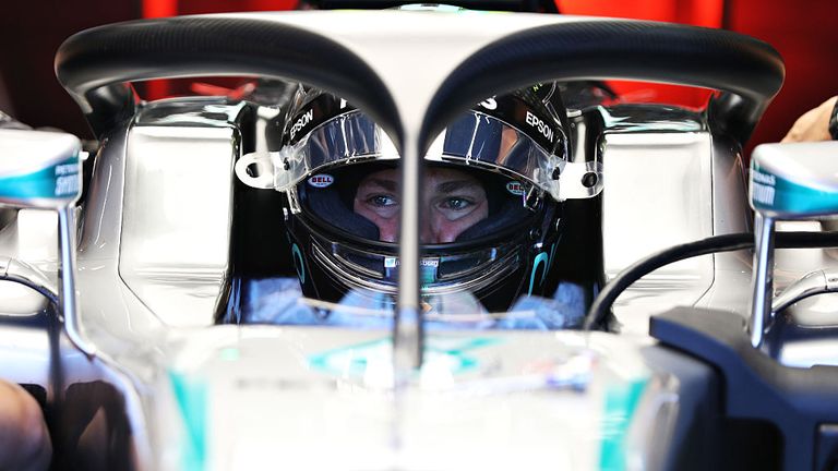 SPA, BELGIUM - AUGUST 26:  Nico Rosberg of Germany and Mercedes GP sits in his car fitted with the halo in the garage during practice for the Formula One G