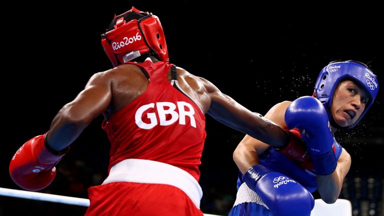 Nicola Adams (L) of Great Britain fights against Cancan Ren of China during a Women's Fly (48-51kg) Semifinal bout