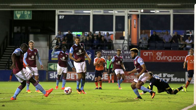 Aston Villa's Jores Okore (left) scores an own goal against Luton Town during the EFL Cup, First Round match at Kenilworth Road, Luton.