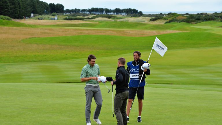 NORTH BERWICK, SCOTLAND - AUGUST 04: Oliver Fisher of England and Peter Uihlein of United States shake hands on the green of hole 18 after their four hole 