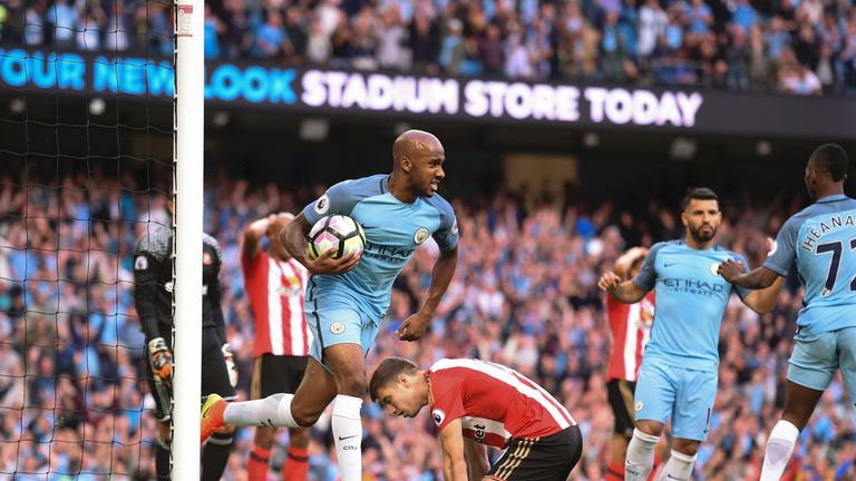 Manchester City's English midfielder Fabian Delph (CL) collects the ball after Sunderland's Northern Irish defender Paddy McNair (CR floor) scored an own g