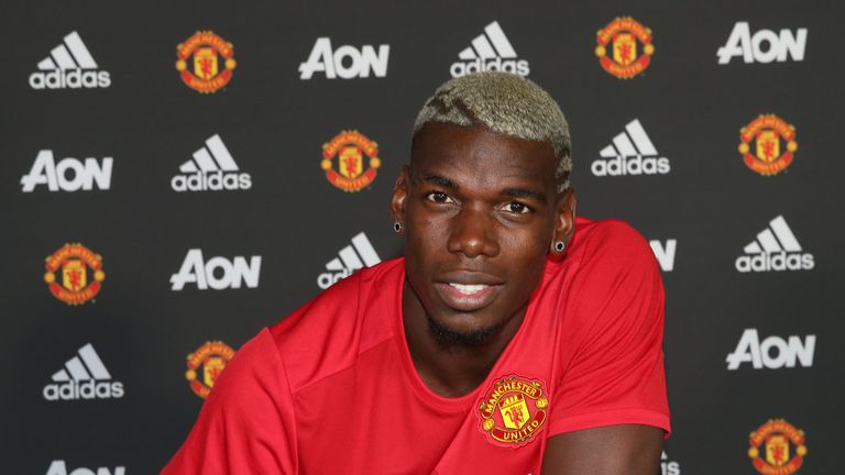 MANCHESTER, ENGLAND - AUGUST 08:  (EXCLUSIVE COVERAGE) Paul Pogba of Manchester United poses after signing for the club at Aon Training Complex on August 8