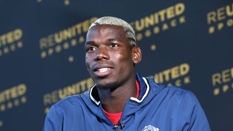 MANCHESTER, ENGLAND - AUGUST 08:  (EXCLUSIVE COVERAGE) Paul Pogba of Manchester United poses after signing for the club at Aon Training Complex on August 8