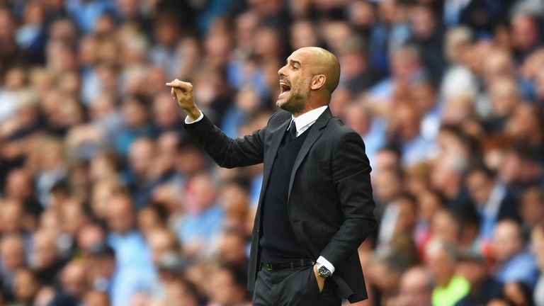 MANCHESTER, ENGLAND - AUGUST 13: Josep Guardiola, Manager of Manchester City shouts instructions to his players on the pitch during the Premier League matc