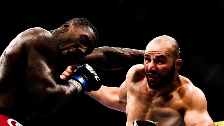 RIO DE JANEIRO, BRAZIL - OCTOBER 25:  Phil Davis of the United States punches Glover Teixeira of Brazil in their light heavyweight bout during the UFC 179 