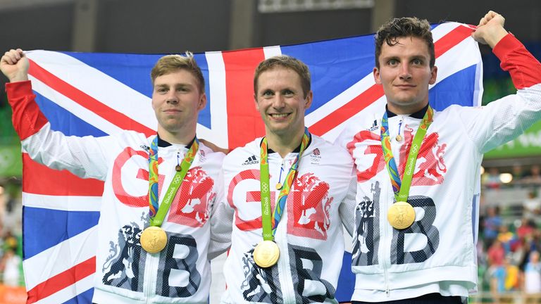 Philip Hindes (L), Jason Kenny (C) and Callum Skinner receive their team sprint gold medals