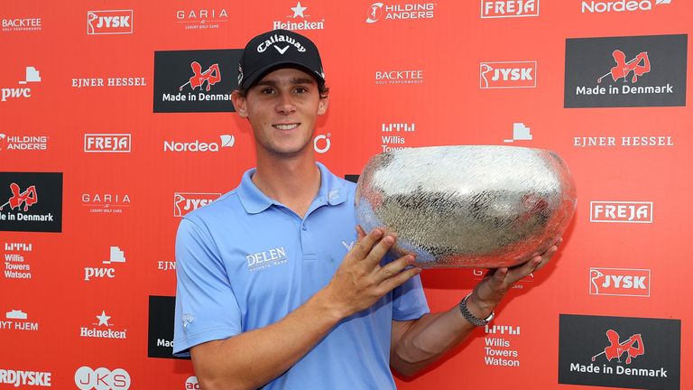 Thomas Pieters of Belgium poses with the trophy following his victory during the final round of Made in Denmark 