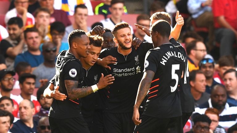 Philippe Coutinho celebrates with his teammates after scoring Liverpool's third goal
