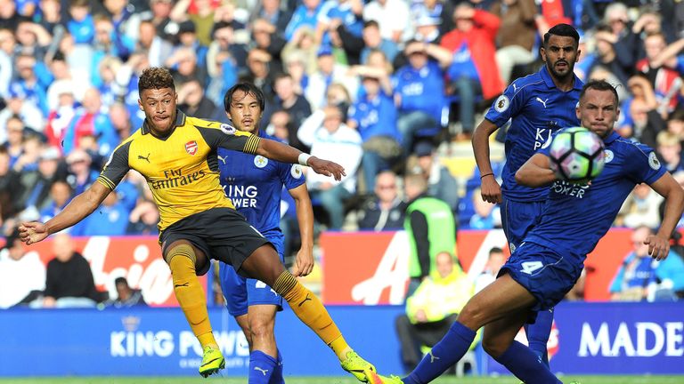 Alex Oxlade-Chamberlain (L) takes a shot at goal under pressure from Danny Drinkwater (R)