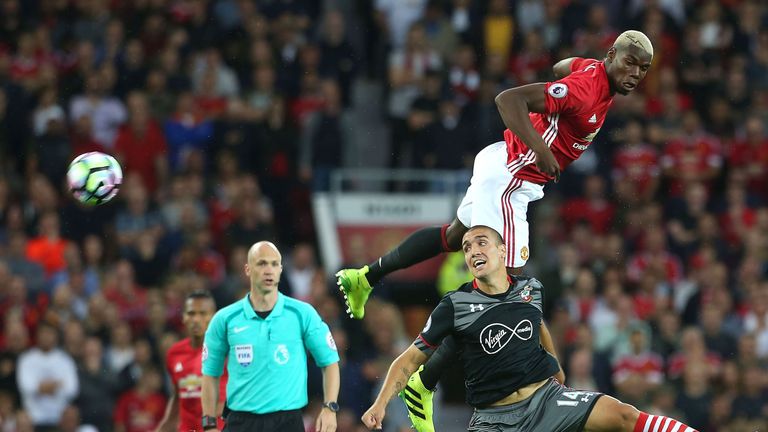 Paul Pogba (R) challenges Oriol Romeu at Old Trafford