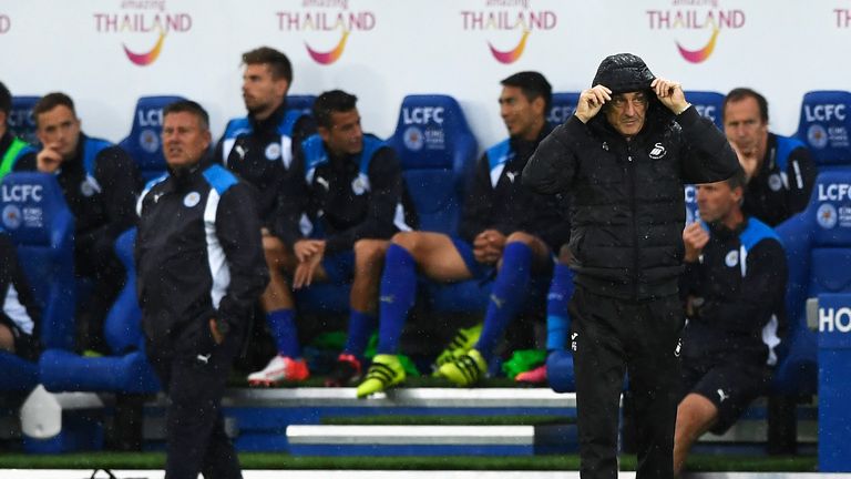 Francesco Guidolin looks on in the rain during the Premier League match between Leicester and Swansea
