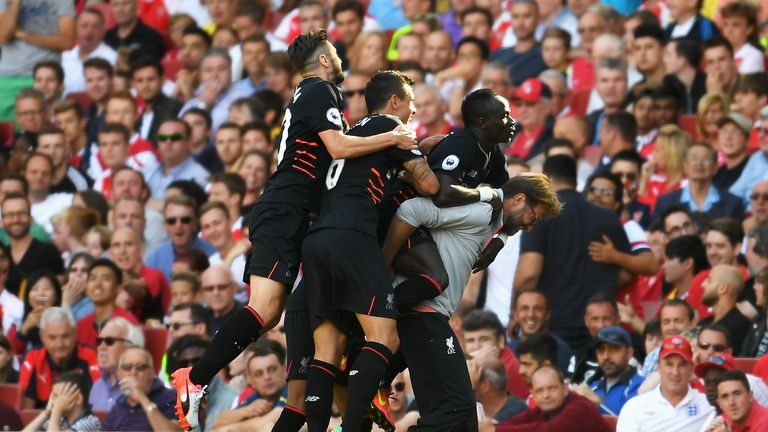Sadio Mane hitches a ride offJurgen Klopp's back as the Liverpool manager animatedly celebrates a goal