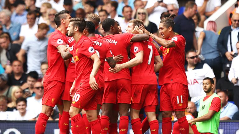 James Milner celebrates with his Liverpool team-mates after scoring the opening goal