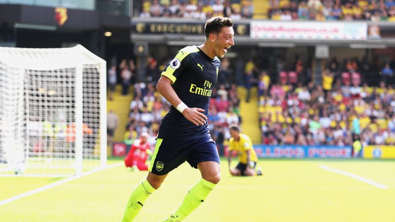 Mesut Ozil celebrates scoring Arsenal's third goal