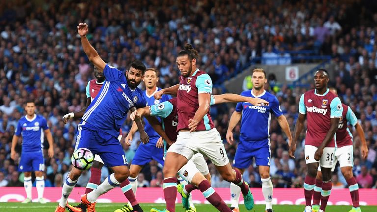 Diego Costa and Andy Carroll battle for possession
