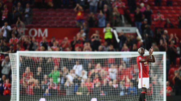 Paul Pogba applauds the fans