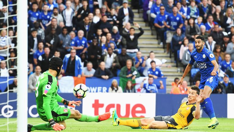 Petr Cech (L) saves a shot on goal from Riyad Mahrez