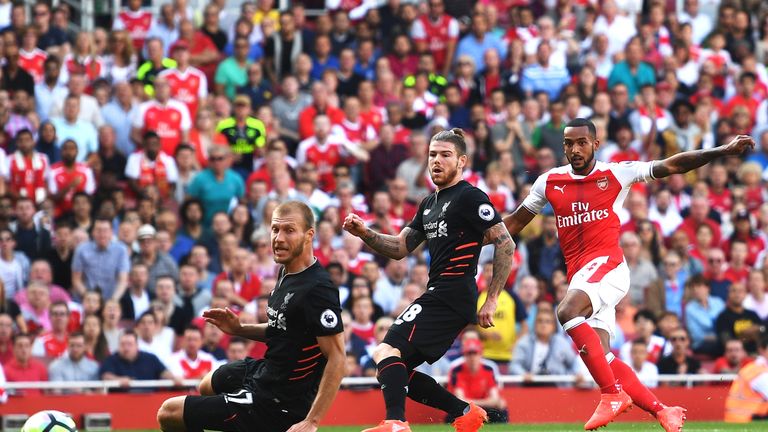 Theo Walcott scores the opening goal of the maych for Arsenal