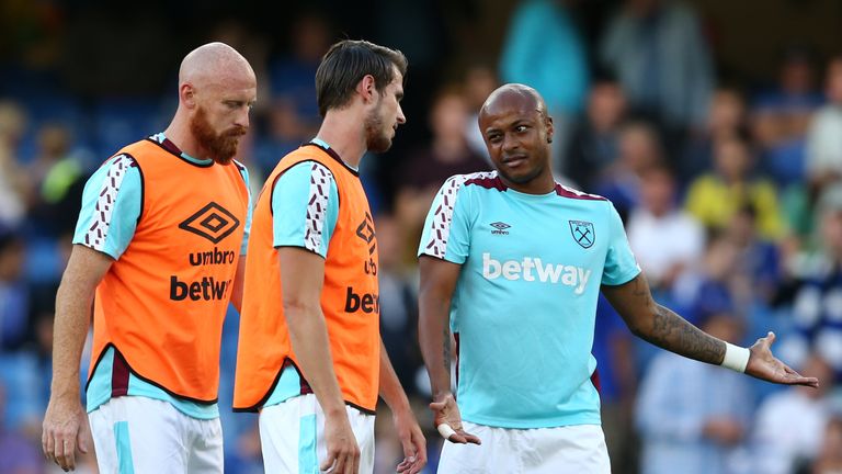 Andre Ayew (R) talks teammates Havard Nordtveit and James Collins prior to kick-off
