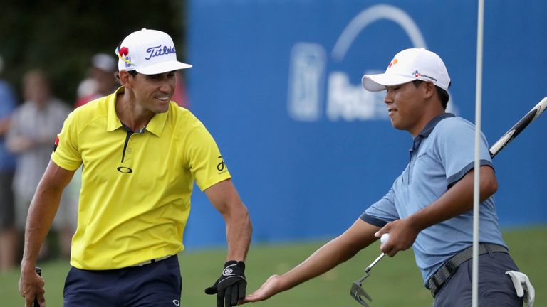 GREENSBORO, NC - AUGUST 21:  (L-R) Rafa Cabrera Bello celebrates after making a shot on the 15th hole with Si Woo Kim during the final round of the Wyndham