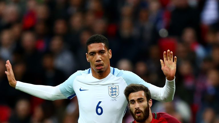 LONDON, ENGLAND - JUNE 02: Rafa Silva of Portugal holds off pressure from Chris Smalling of England during the international friendly match between England