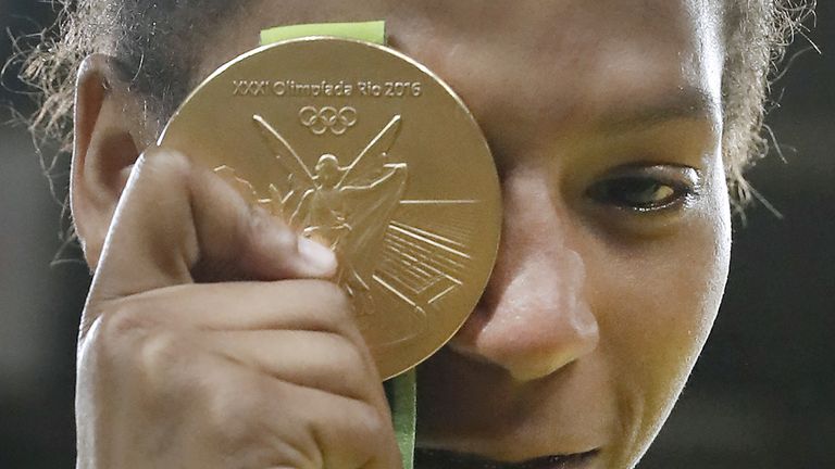 Brazil's Rafaela Silva celebrates with her gold medal following the women's -57kg judo contest of the Rio 2016 Olympic Games in Rio de Janeiro on August 8,