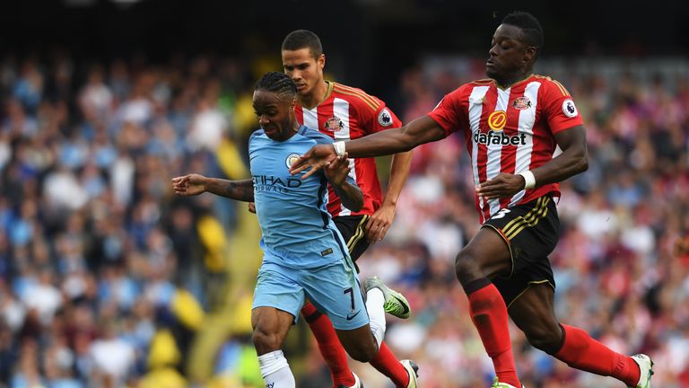 MANCHESTER, ENGLAND - AUGUST 13:  Raheem Sterling of Manchester City battle for possession with Lamine Koné of Sunderland during the Premier League match 