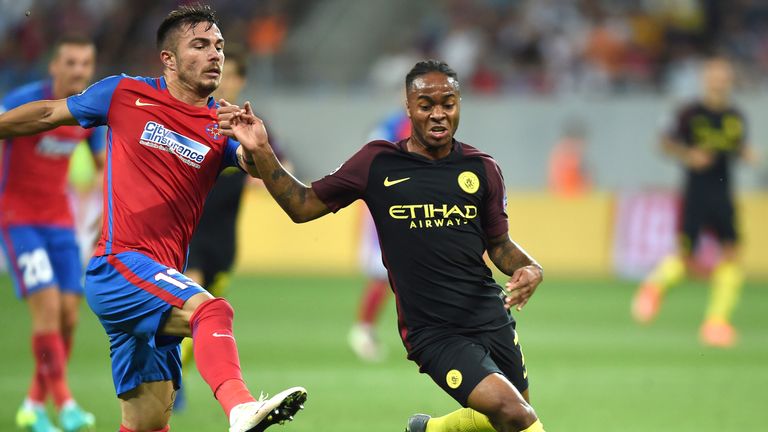Raheem Sterling (R) vies for the ball with defender Alin Tosca
