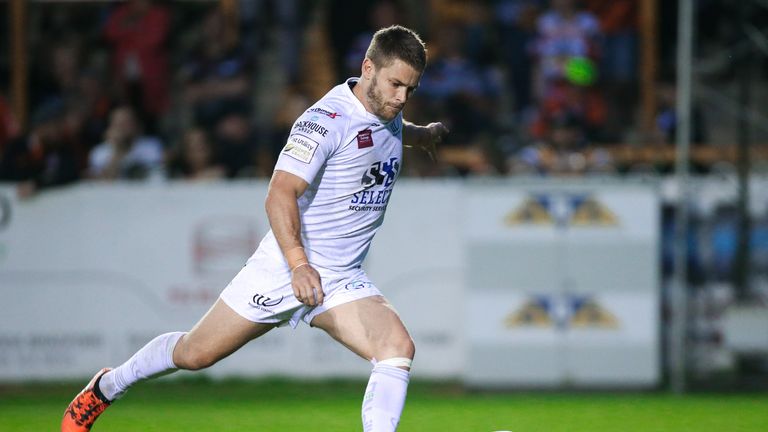 Widnes' Rhys Hanbury kicks for goal.