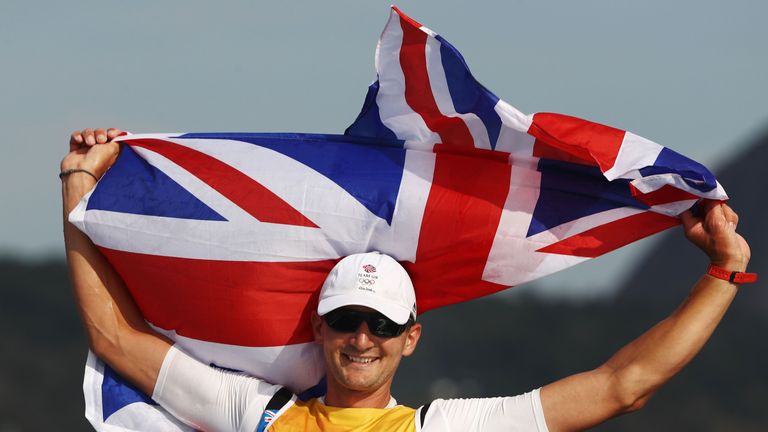 Great Britain's Giles Scott celebrates winning gold in the finn class