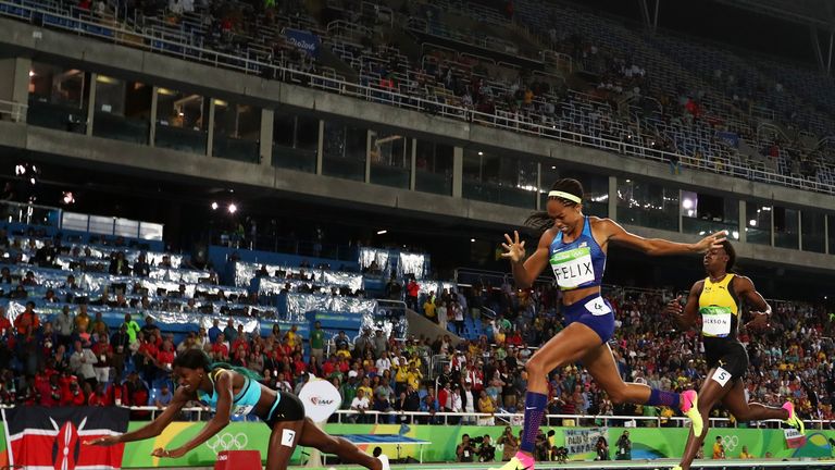 Shaunae Miller of the Bahamas (L) dives over the finish line to win the gold medal in the Women's 400m Final at Rio Olympics
