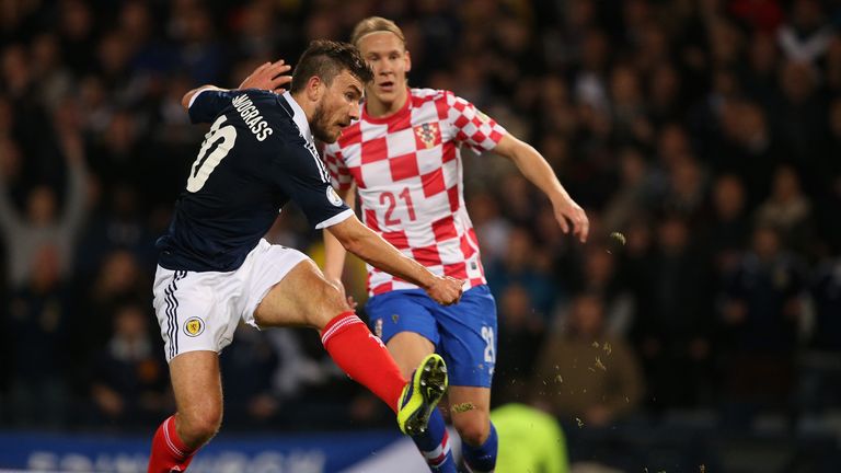 GLASGOW, SCOTLAND - OCTOBER 15:  Robert Snodgrass of Scotland shoots watched by Domagoj Vida of Croatia to score the first goal during the FIFA 2014 World 