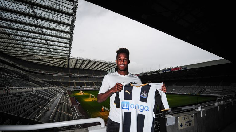 Rolando Aarons poses for photographs with the Newcastle home shirt in the stands over looking the pitch after signing a ne