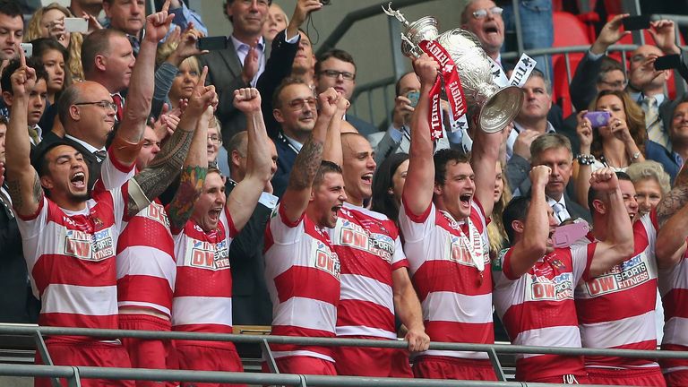 Wigan Warriors' Sean O'Loughlin lifts the winners trophy after the 2013 Tetley's Challenge Cup Final against Hull