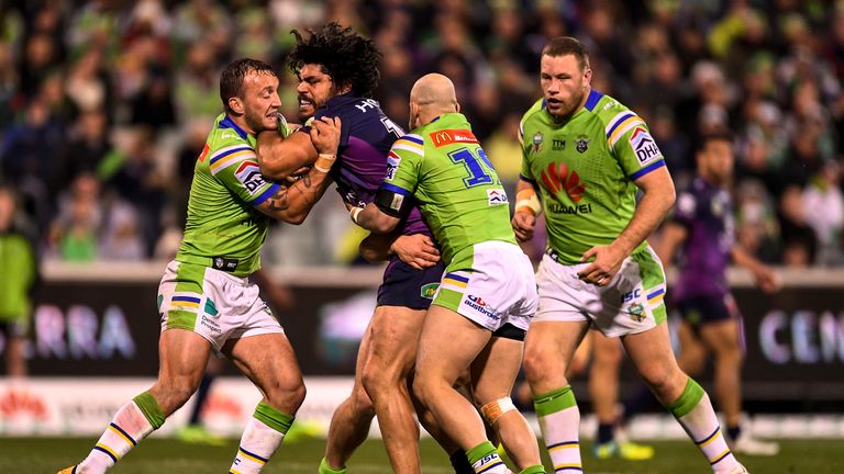 Tohu Harris is tackled by Canberra Raiders duo Josh Hodgson and Kurt Baptiste