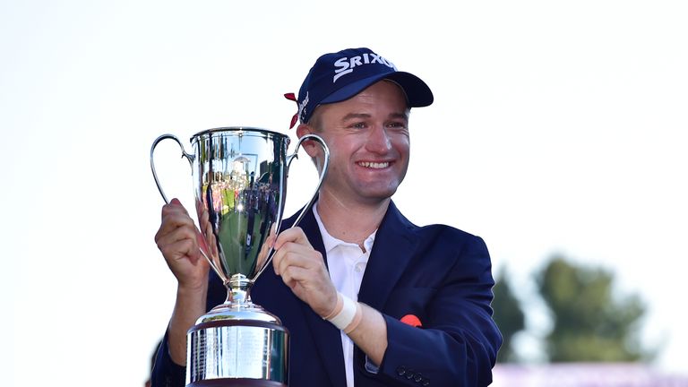Russell Knox of Scotland poses with the trophy after winning the Travelers Championship