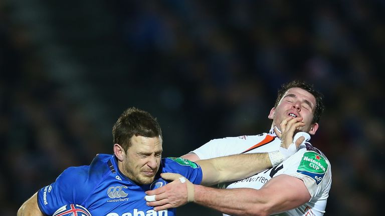 DUBLIN, IRELAND - JANUARY 17:  Jimmy Gopperth (L) of Leinster is held up by Ryan Bevington (2L) of Ospreys during the Heineken Cup Pool One match between |