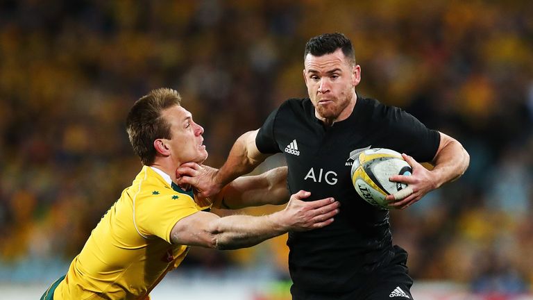 Ryan Crotty of the All Blacks fends off Dane Haylett-Petty of the Wallabies