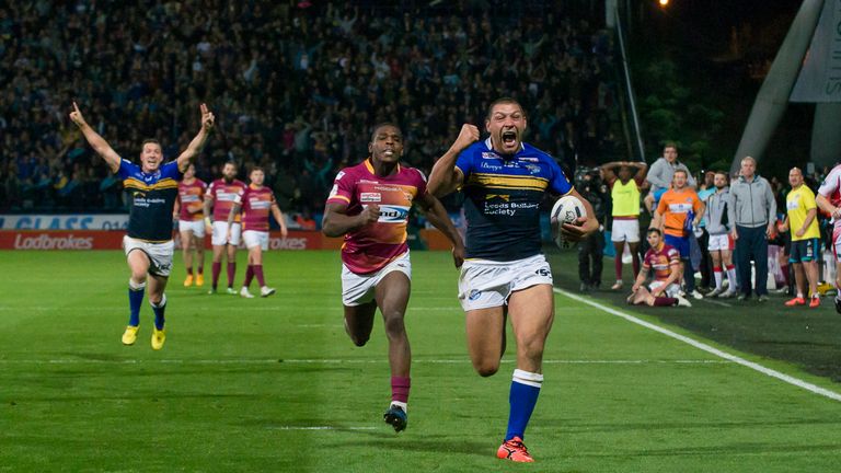 Leeds's Ryan Hall celebrates as he outpaces Huddersfield's Jermaine McGillvary to score the winning try.