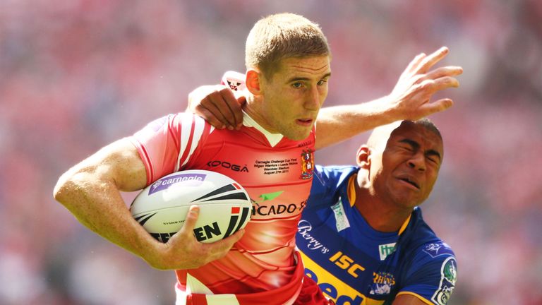 LONDON, ENGLAND - AUGUST 27: Sam Tomkins of Wigan Warriors is tackled by Kallum Watkins of Leeds Rhinos during the Carnegie Challenge Cup Final between Lee