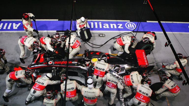 SINGAPORE - SEPTEMBER 27:  Lewis Hamilton of Great Britain and McLaren Mercedes drives in for a pitstop during the Singapore Formula One Grand Prix at the 