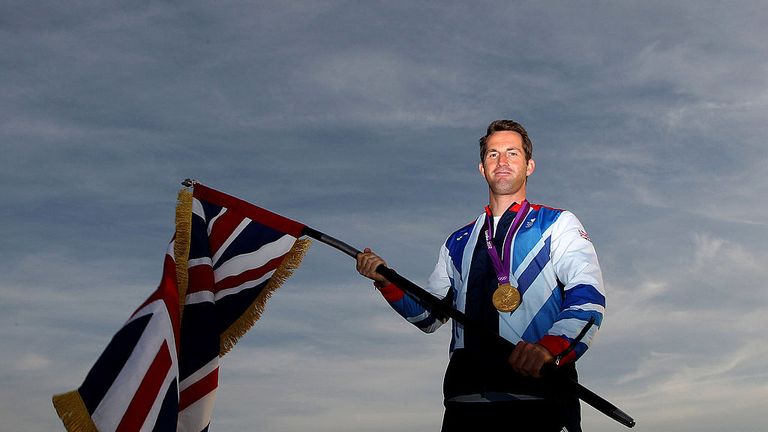 Olympic gold medallist Ben Ainslie poses with the GB flag ahead of the closing ceremony in London