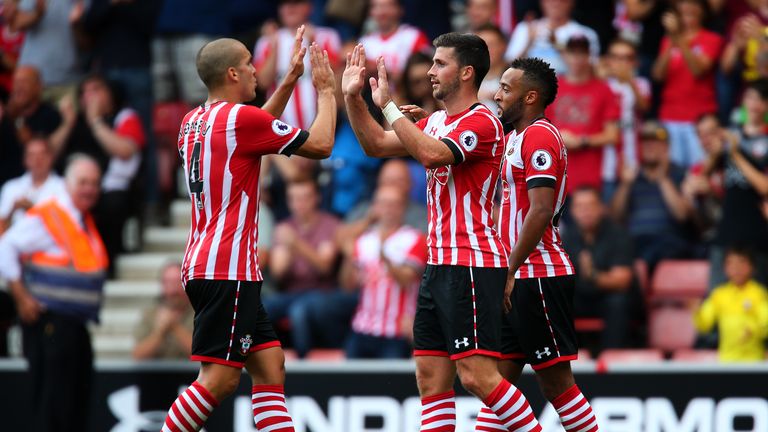 SOUTHAMPTON, ENGLAND - AUGUST 07:  Shane Long of Southampton (C) celebrates with Oriol Romeu of Southampton (L) after scoring his sides first goal during t